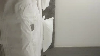 看一个年轻的大学女孩在宿舍房间里试镜新的业余视频